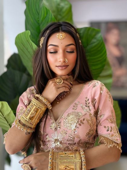 A soft, romantic look for an engagement or pre-wedding shoot. The pink tones and gold jewelry create a dreamy vibe.