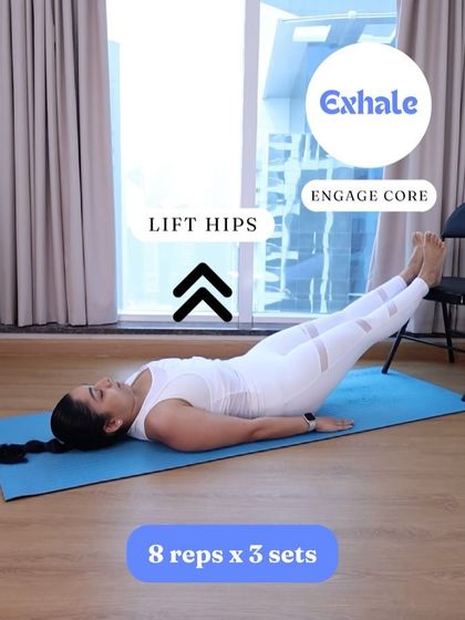 This image demonstrates an elevated feet reverse plank. Using a chair increases the challenge on your glutes and hamstrings while still safely engaging your core as you lift.