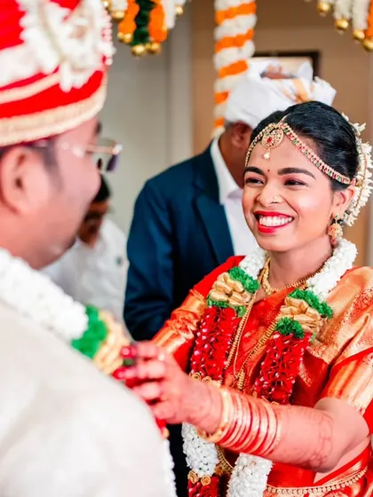 A candid moment of pure happiness between the bride and groom during their Maharashtrian wedding ceremony. We focus on capturing these genuine smiles and interactions that tell the real story of the day.