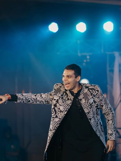 Just a groom and his swag on the dance floor. This candid shot captures the confidence and fun of his sangeet performance.