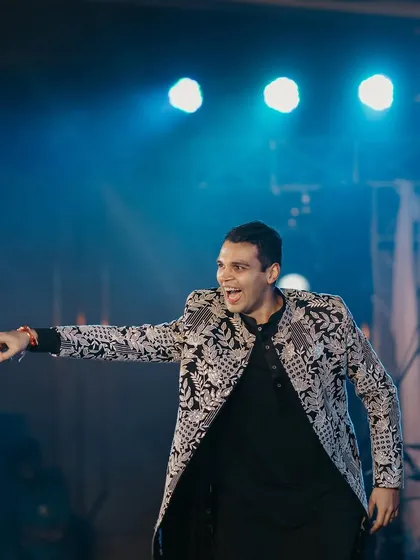 Just a groom and his swag on the dance floor. This candid shot captures the confidence and fun of his sangeet performance.