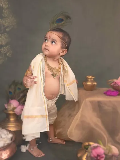 The combination of the painted tree backdrop and the traditional brass pots creates a rich, layered composition that draws inspiration from classical Indian art.