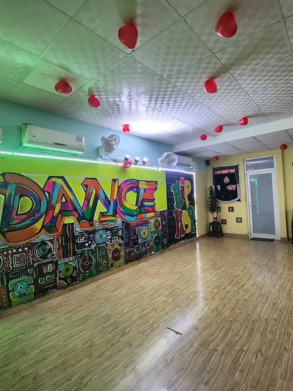 Welcome to my studio in Noida Sector 137. With professional wooden flooring and vibrant graffiti art, it's a space designed to inspire you the moment you walk in.