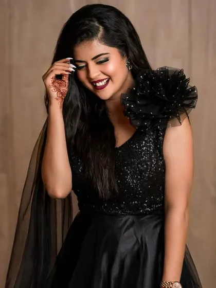 A candid, happy shot from the same photoshoot, showing a different side of the glamorous look.