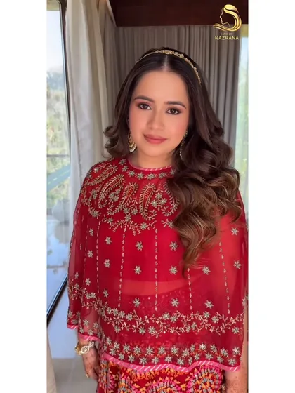 A radiant client ready for her Udaipur wedding event with her hair in soft, open waves.