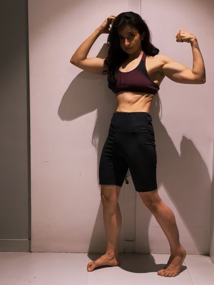 Feeling stronger one session at a time. This pose is a celebration of the muscle and strength I've built through consistent home workouts.