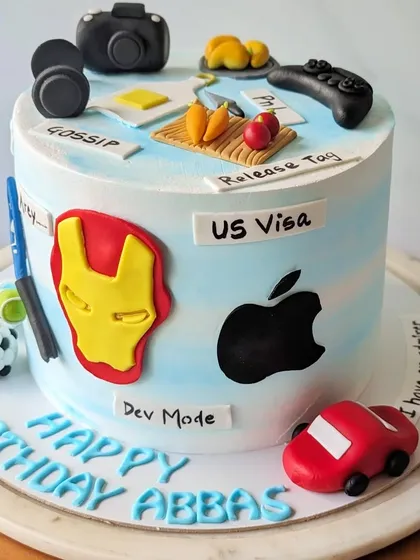 The third view of this highly detailed cake shows a camera, headphones, and a small car. Grouping multiple personal elements together is a great way to celebrate everything that makes a person unique.