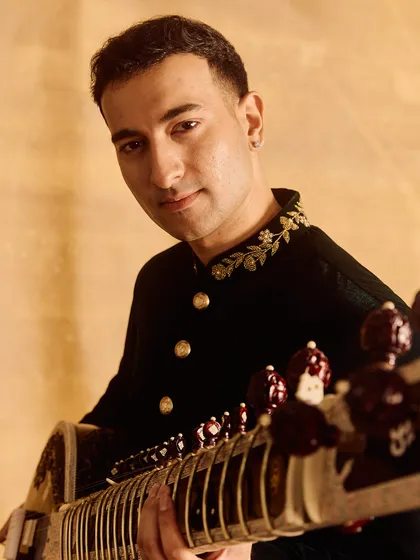 A close, intimate portrait. The focus is on the expression and the details of the instrument.