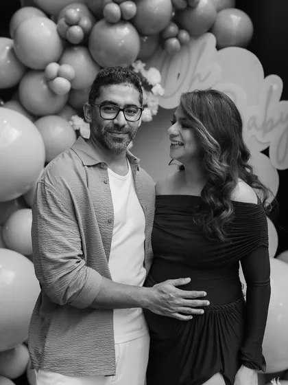 A timeless black and white portrait of the happy couple, capturing a quiet moment of joy and anticipation during their beautifully styled baby shower.