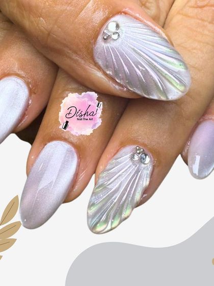 Elegant and ethereal. This design features a pearlescent white base with sculpted 3D shell textures and a single rhinestone accent for a touch of understated sparkle.