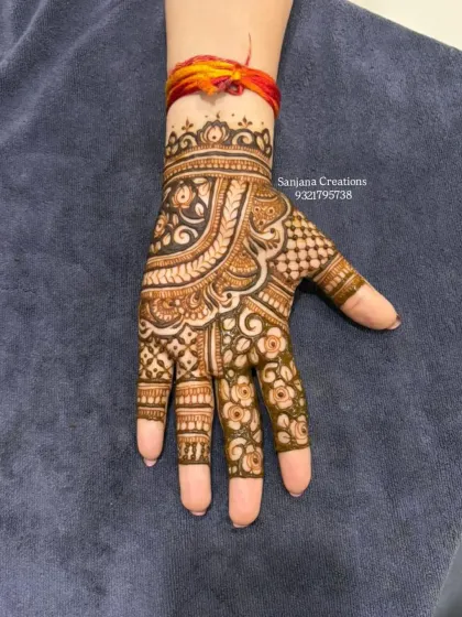 A beautiful and intricate design for the front of the hand, perfect for a wedding guest.