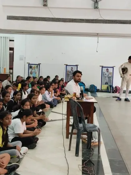 Our head coach addresses a hall full of attentive students. These group sessions are vital for discussing strategy, sharing lessons from competitions, and reinforcing our club's values.