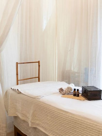 The spa bed is waiting for you. This clean, minimalist setup is the perfect canvas for a relaxing and rejuvenating treatment.