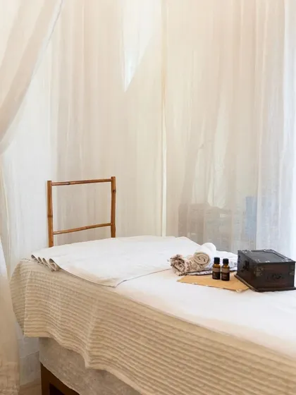 The spa bed is waiting for you. This clean, minimalist setup is the perfect canvas for a relaxing and rejuvenating treatment.