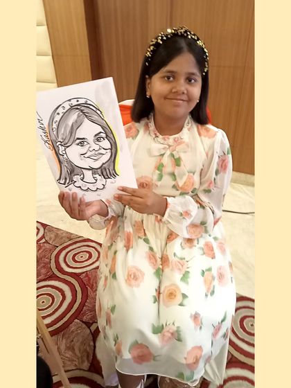 A sweet photo of a party guest with her finished drawing. It's a memento she can put up in her room.