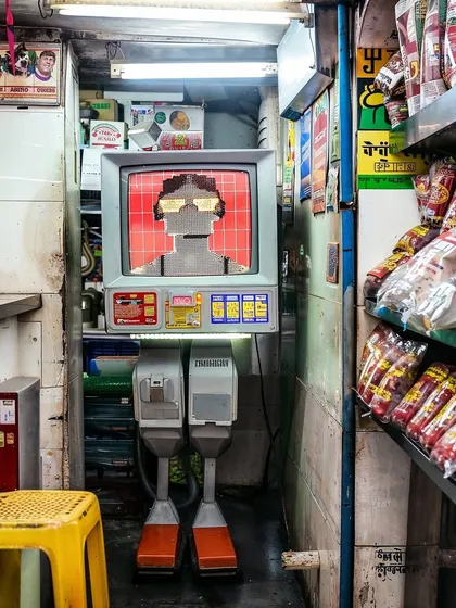 A full-body view of a 'kiranatech' robot, showing its clunky, retro design. It's a blend of a CRT monitor, a computer, and a pair of legs, designed to fit into a cramped shop.