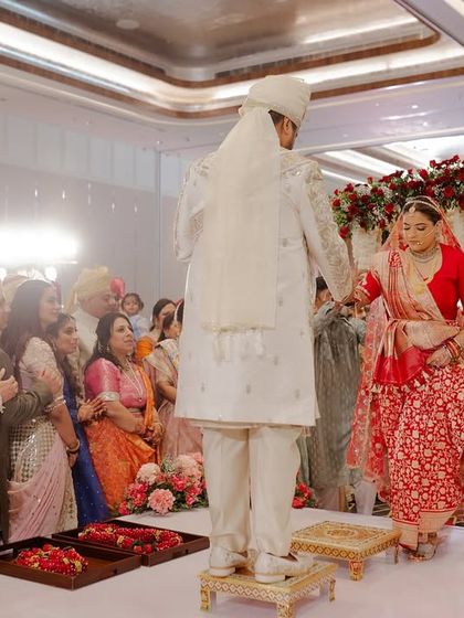 The bride and groom taking their first steps together as a married couple during the pheras. We design the mandap layout to be both beautiful and functional for all the rituals.