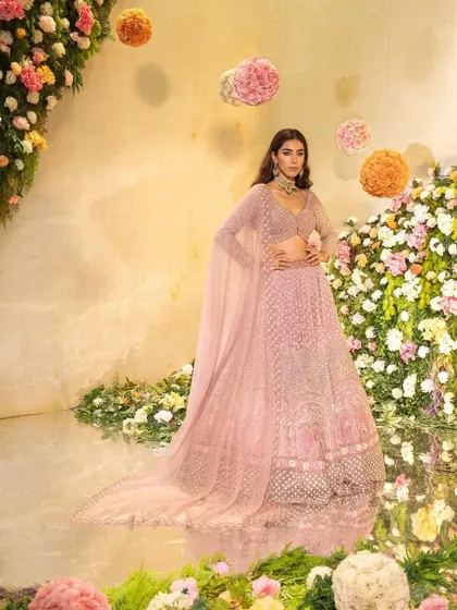 A full-length shot with a beautiful reflection, highlighting the grandeur of the lehenga.