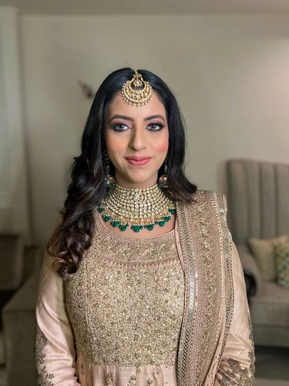 A close-up portrait, her makeup looking fresh and flawless.