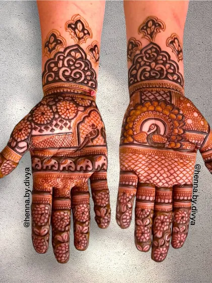 A royal-themed design featuring peacocks and elephants. The use of arches and traditional borders gives this mehendi a majestic and grand appearance.
