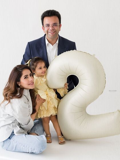 A formal family portrait celebrating their daughter's second birthday. It's a beautiful, classic image to mark this special milestone.