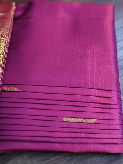 The back of a magenta silk saree, showing the neatness of the box fold.