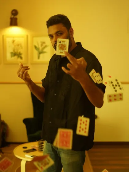 This shot captures the dynamic energy of my card magic. My style is all about creating moments of pure illusion and wonder, right in front of your eyes. It’s not about stage tricks, but about making the impossible happen in your hands.