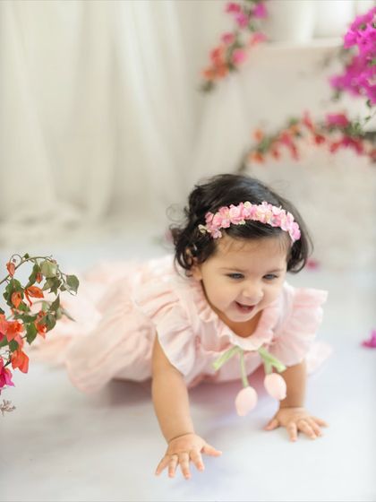 On the move. At ten months, many babies are crawling, and I love to capture that energy and movement, like this happy baby girl mid-crawl.
