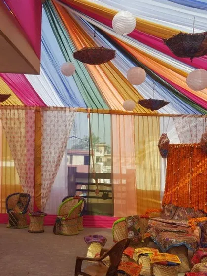 Another angle of our full roof decoration for a pre-wedding event. This shows how we can transform a residential terrace into a complete venue space with seating arrangements under a vibrant tent.