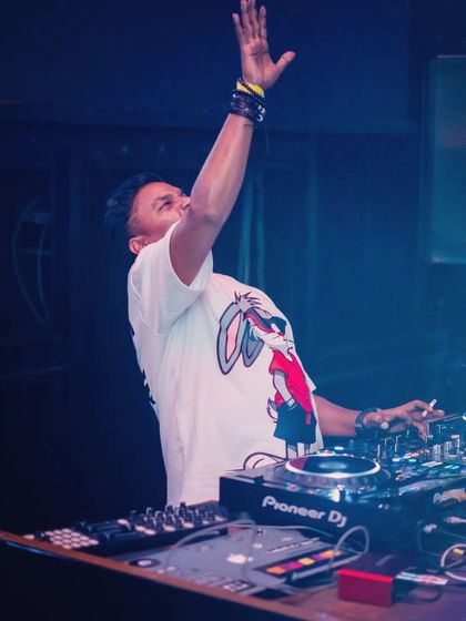 Hands up for the music. A moment of pure joy and connection with the crowd during a high-energy progressive house set.