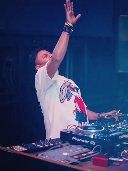 Hands up for the music. A moment of pure joy and connection with the crowd during a high-energy progressive house set.