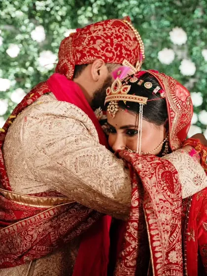 A tender embrace after the completion of the wedding rituals. This photograph captures the emotional culmination of the ceremony and the beginning of their new journey.