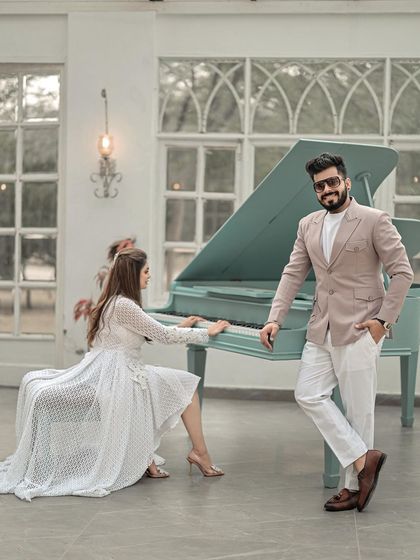 A stylish and confident portrait of the couple with a piano. This shot has a relaxed, editorial feel, perfectly capturing their modern and chic style.