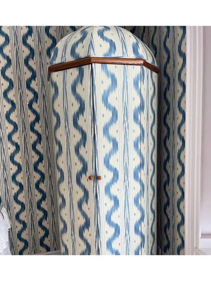 I believe in pushing creative boundaries. Here, an ikat-inspired fabric transforms a simple wardrobe into a showstopping piece of furniture. This is how I approach bespoke design, finding unique opportunities to apply textiles beyond the expected.