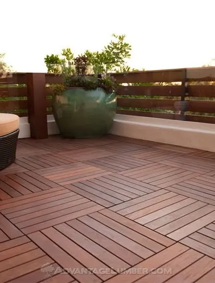 A stylish patio floor made from interlocking wooden deck tiles. This modular system is a versatile and attractive option for covering concrete balconies, patios, or rooftops.