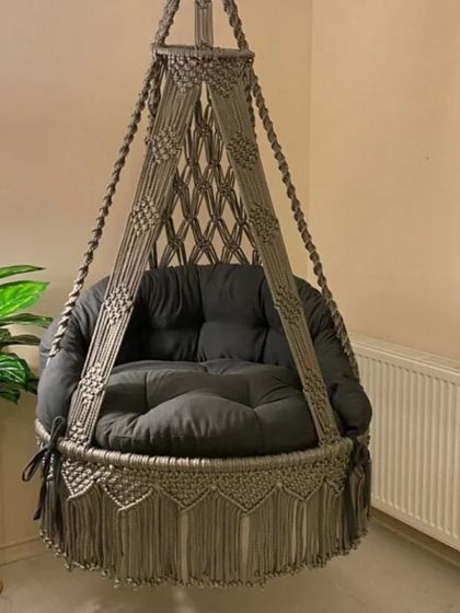 This grey swing with a simple, elegant design is perfect for a modern home. The dark cushion provides a nice contrast and a comfortable seat.