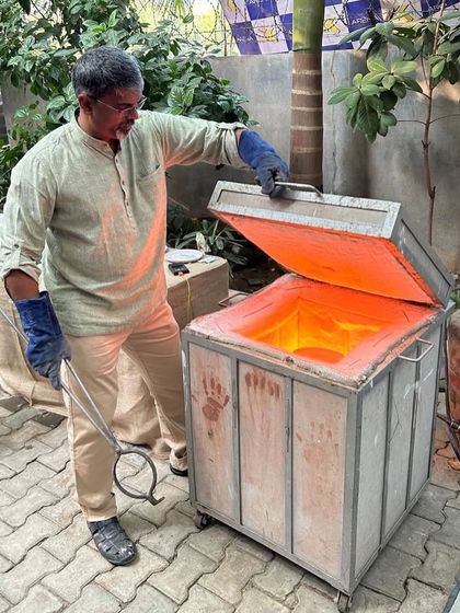 Here I am, ready with tongs to remove a piece from the Raku kiln. This hands-on process is what makes our Raku workshops so immediate and exciting, giving you a direct role in the creation of your ceramic art.