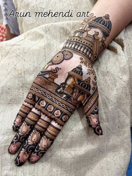 A single hand design filled with traditional motifs like a doli, kalash, and lotus flowers.