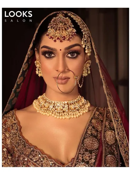 This is the quintessential modern bridal look I love to create. The focus is on dramatic, smokey eyes and flawless HD skin, complemented by bold, traditional jewelry. It’s a perfect example of how I balance contemporary techniques with timeless bridal elegance.