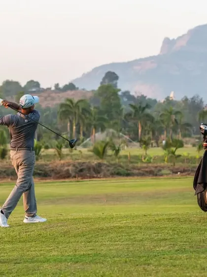 A player takes a full swing against the scenic backdrop of the mountains. This is just a glimpse of a typical day at 9 Aces.