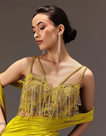 This look for Kalki Fashion features a clean updo and soft, glowing makeup. The style is designed to be elegant and understated, allowing the vibrant yellow outfit to stand out.