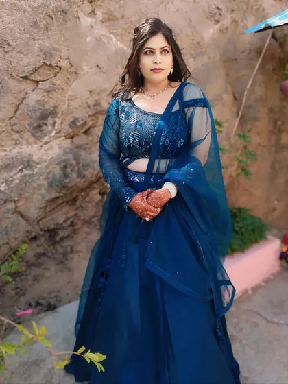 A full-length view of this client's engagement look. The royal blue lehenga and soft makeup create a balanced and beautiful style.