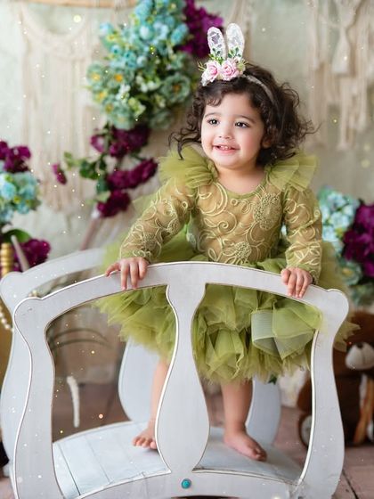 A happy smile from the birthday girl on a little white bridge. Themed sessions are filled with different props and spots to create a variety of beautiful photos.