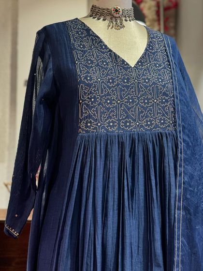 A beautiful indigo Anarkali with a pleated flare, featuring delicate embroidery on the yoke, paired with a matching dupatta.
