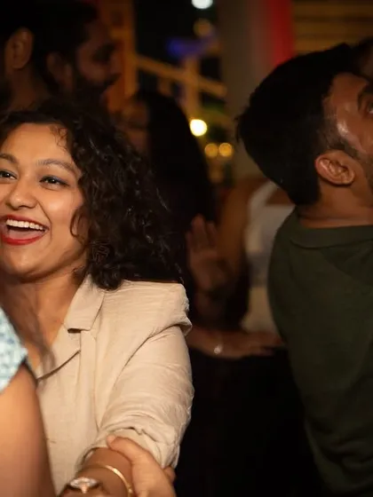 A happy face in the crowd, smiling and dancing along to the music.