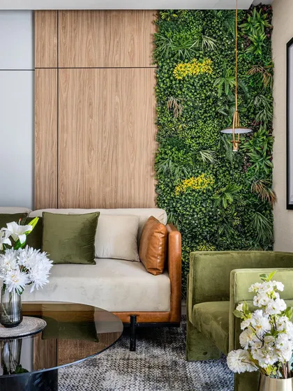 We often incorporate biophilic design to bring a sense of calm and nature into our projects. This living area features a full-height vertical garden wall, which acts as a living piece of art and improves the indoor environment, complementing the wood paneling and modern furniture.