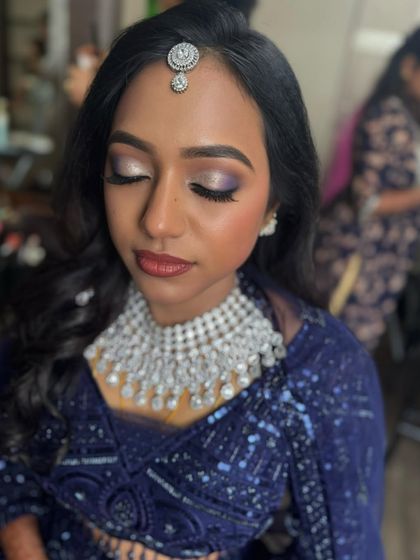 A close-up of Dr. Akshara's reception eye makeup. This look features a beautiful silver and purple smoky eye with a sharp wing, creating a dramatic and glamorous effect.