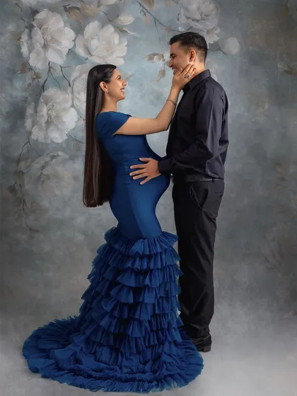 A beautiful, romantic pose that highlights the mom-to-be's stunning silhouette in this blue gown.