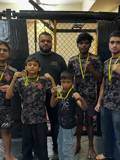 Standing with my team of champions after a weekend of dominant performances. My guidance helps them translate raw talent into medals.