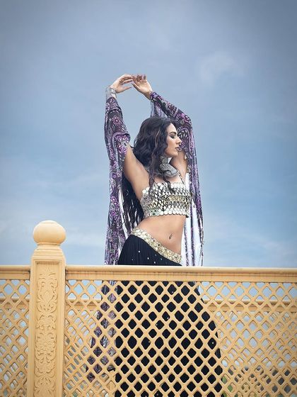 A dramatic shot against the sky, capturing a sense of freedom and movement in this beautiful ensemble by Sajeda Lehry.